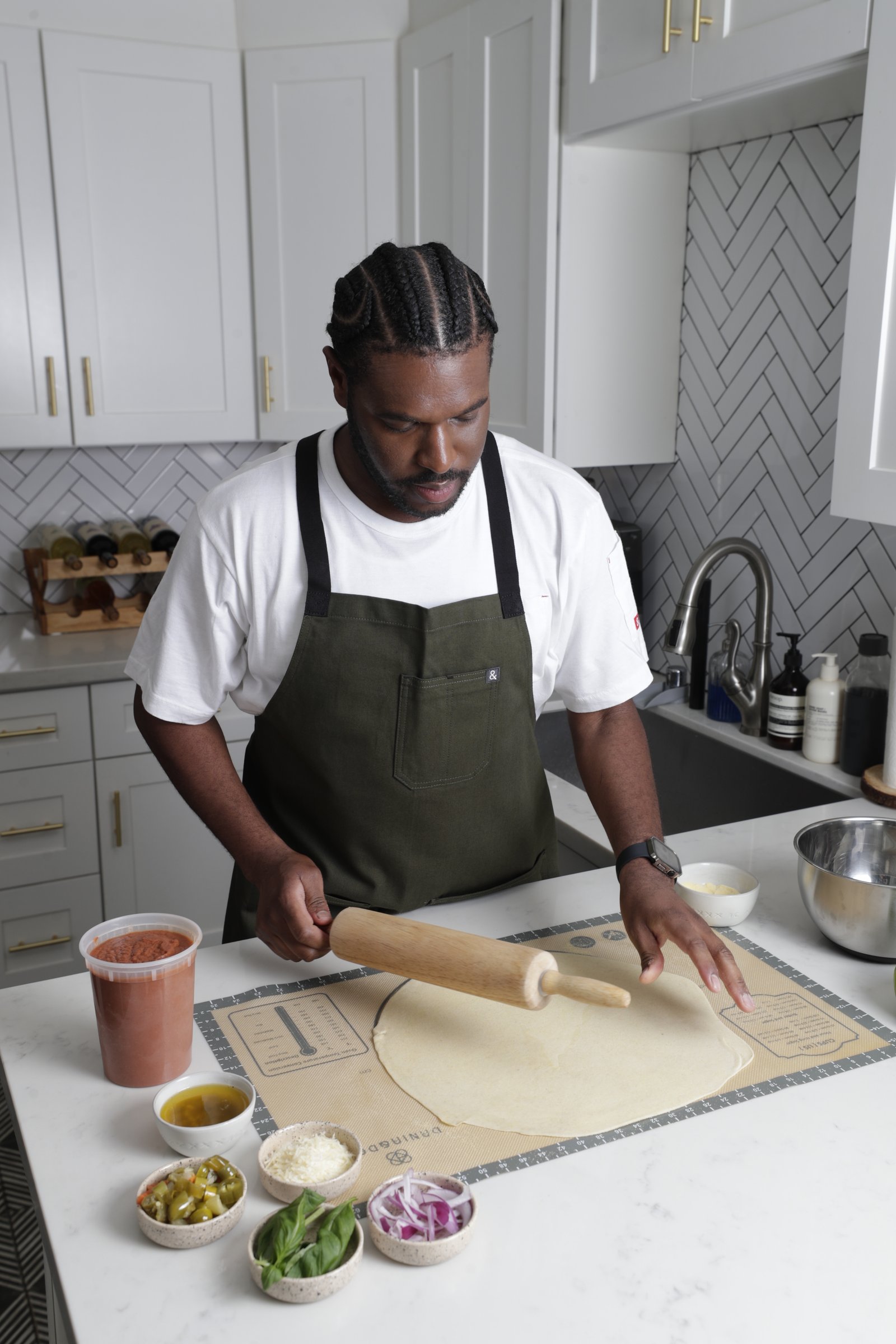 Mike, founder of Morros & Squares, rolling pizza dough